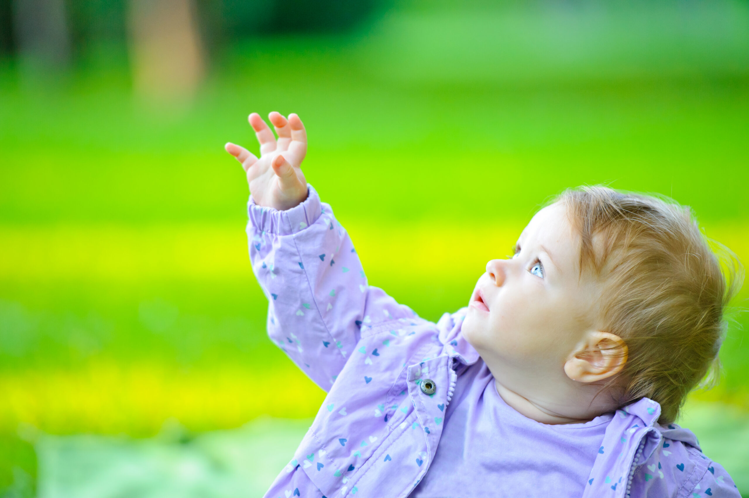 Little girl reaching out her hand